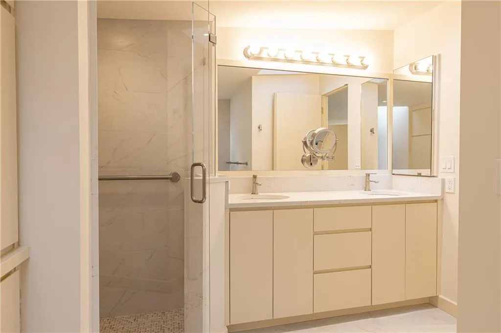 Primary Bathroom with double vanity and walk in shower