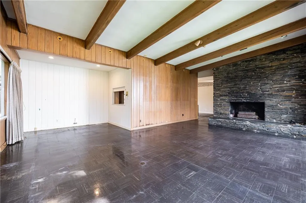 Formal living room with stacked stone fireplace