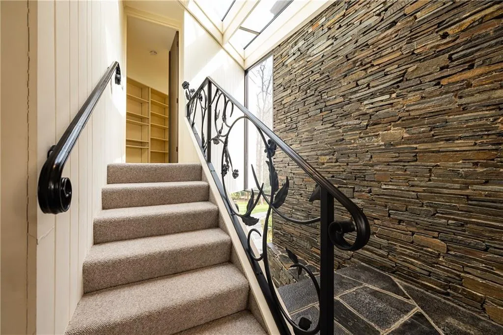 Stairway to primary suite on half second level