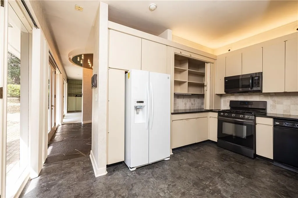 Entry from carport to kitchen flows to common areas