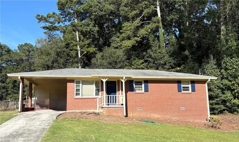 Brick exterior with blue shutters, covered carport, and a front entry porch