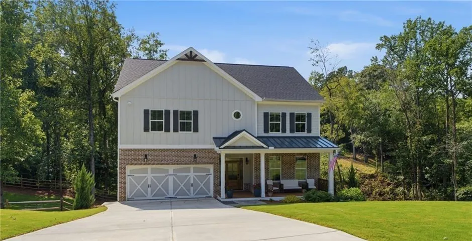 Two-story exterior with board and batten siding and brick detailing