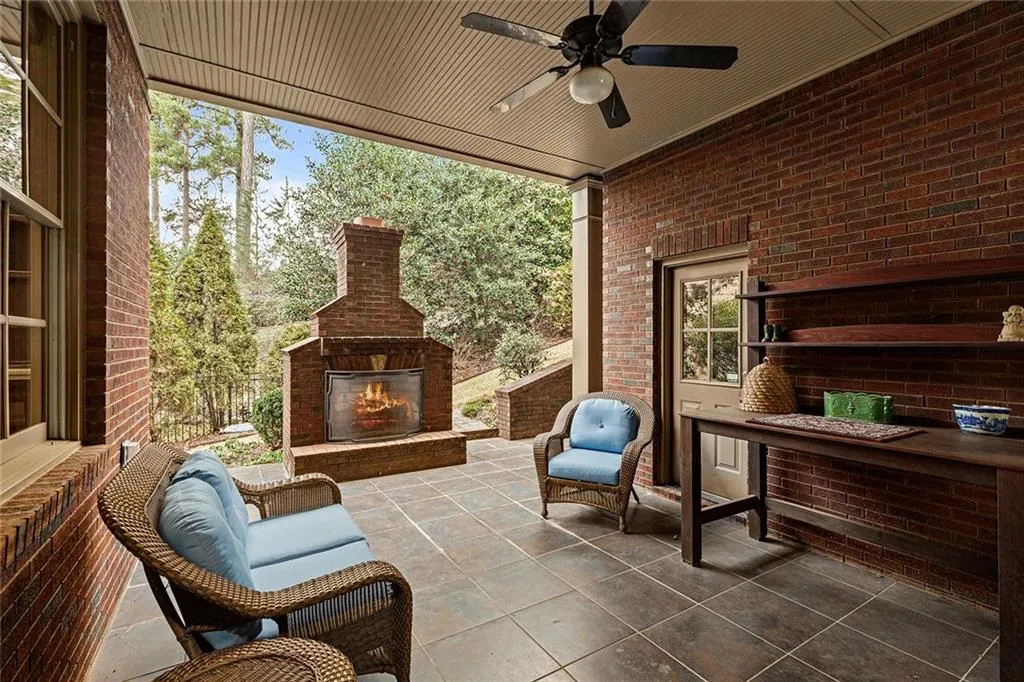 View of patio / terrace featuring ceiling fan and exterior fireplace