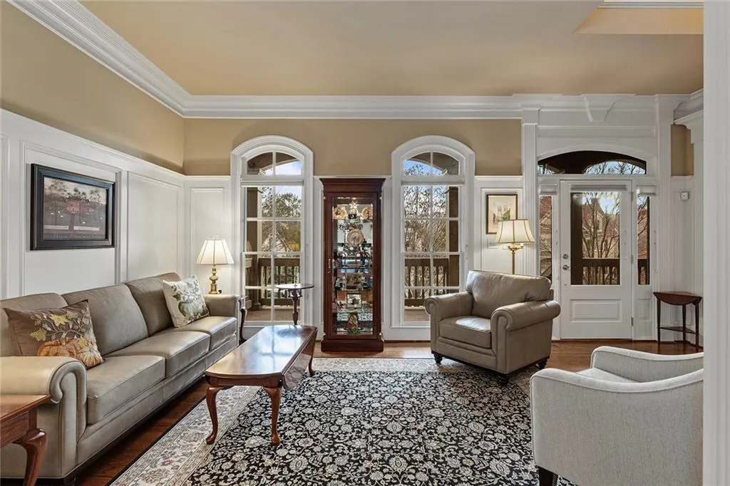 Living room with hardwood / wood-style floors, crown molding, and plenty of natural light