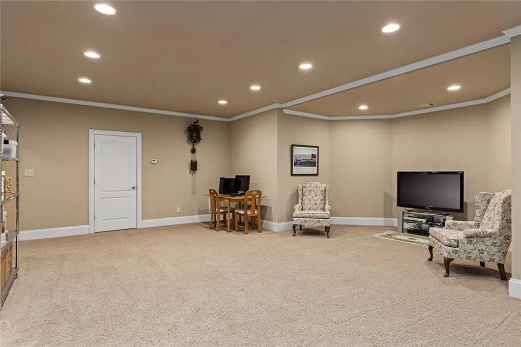 Living area with light carpet and crown molding