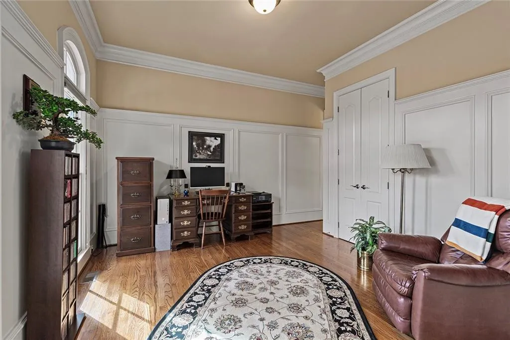 Office space featuring crown molding and hardwood / wood-style floors