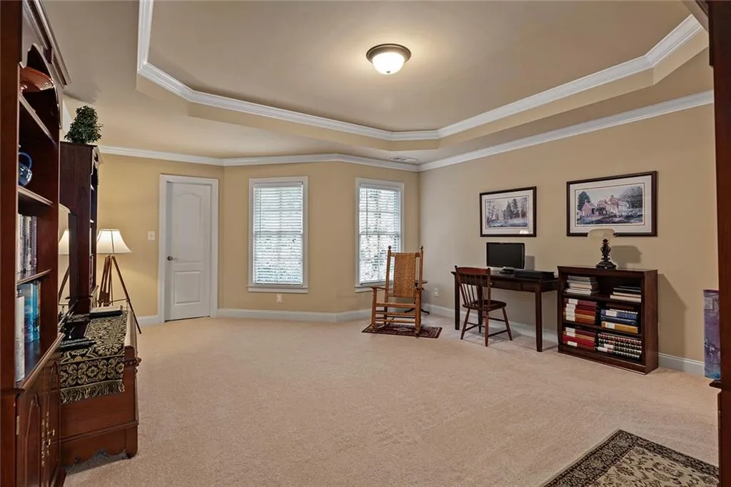 Bedroom with ornamental molding and a tray ceiling