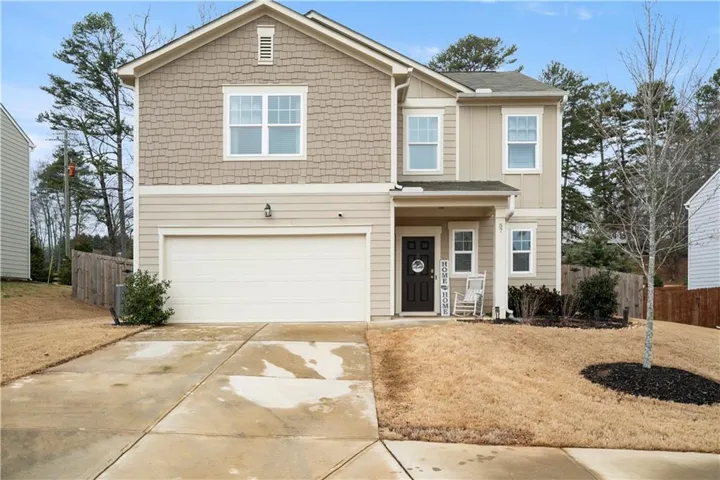 Two-story exterior with shake siding and vertical paneling accents