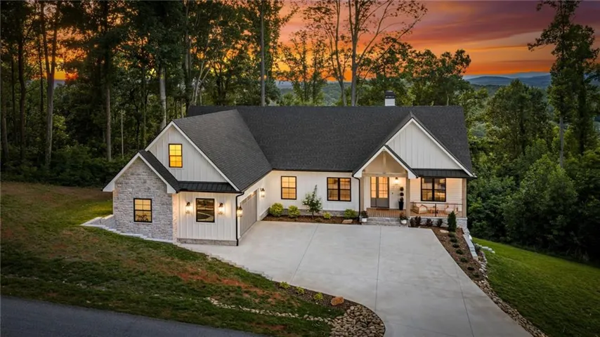 Modern farmhouse exterior featuring board and batten siding and stone accents