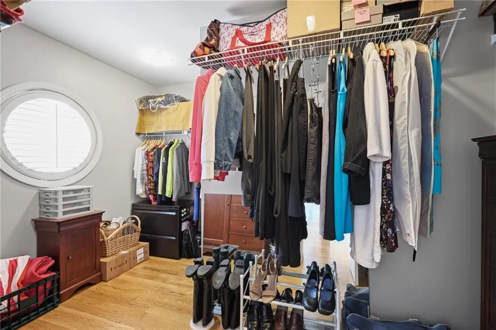 Walk in closet with wood finished floors