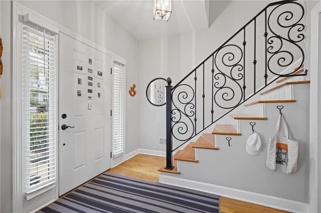 Entrance foyer with light wood-style floors and stairs