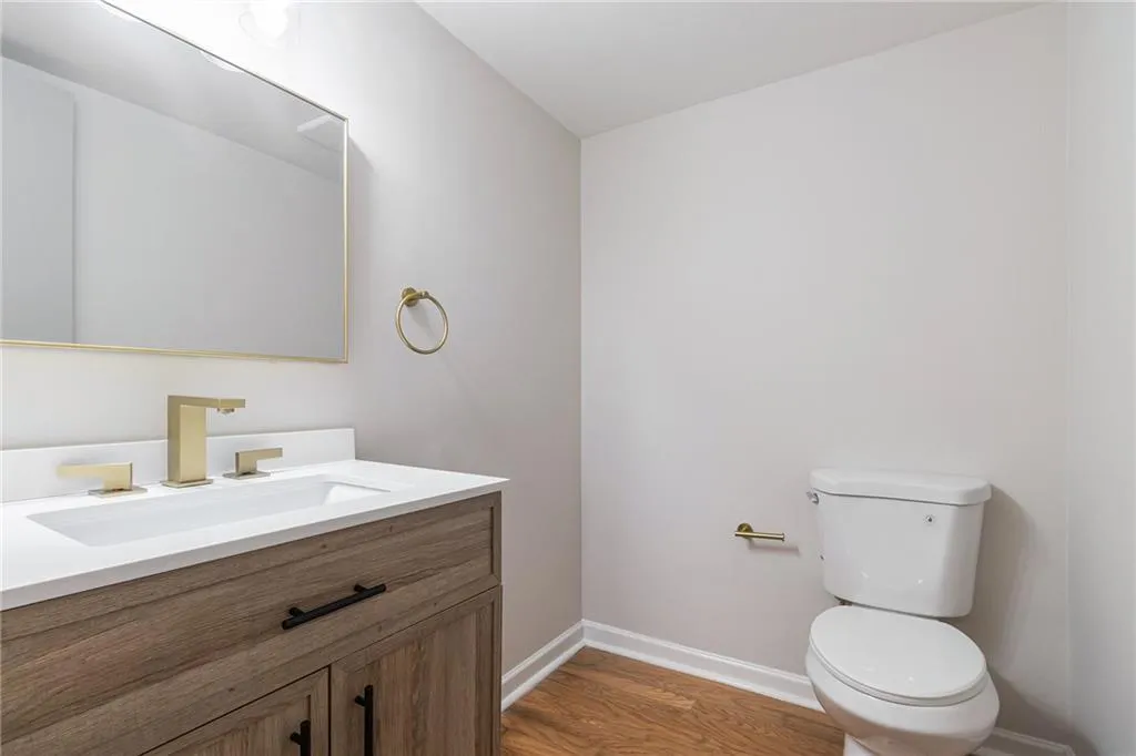 Half bath featuring vanity and light wood-style floors