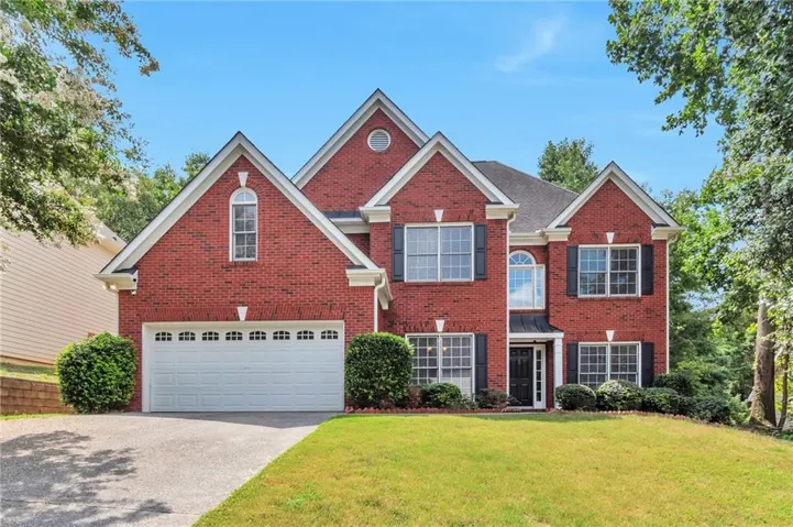 Red brick facade with multiple gables and white trim
