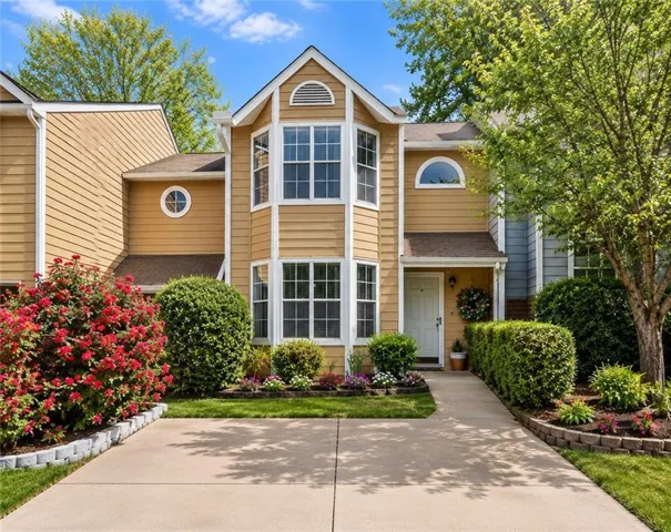 Two-story residential exterior featuring a prominent bay window with multiple panes