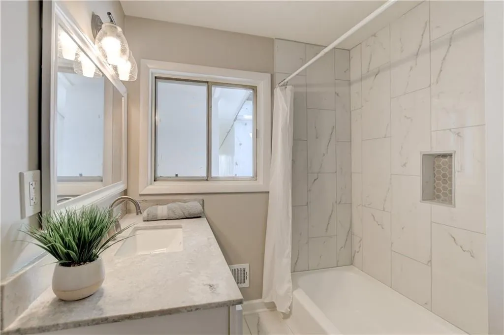 Bathroom featuring shower / tub combo and vanity