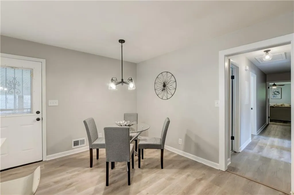 Dining area featuring light wood-style flooring and baseboards