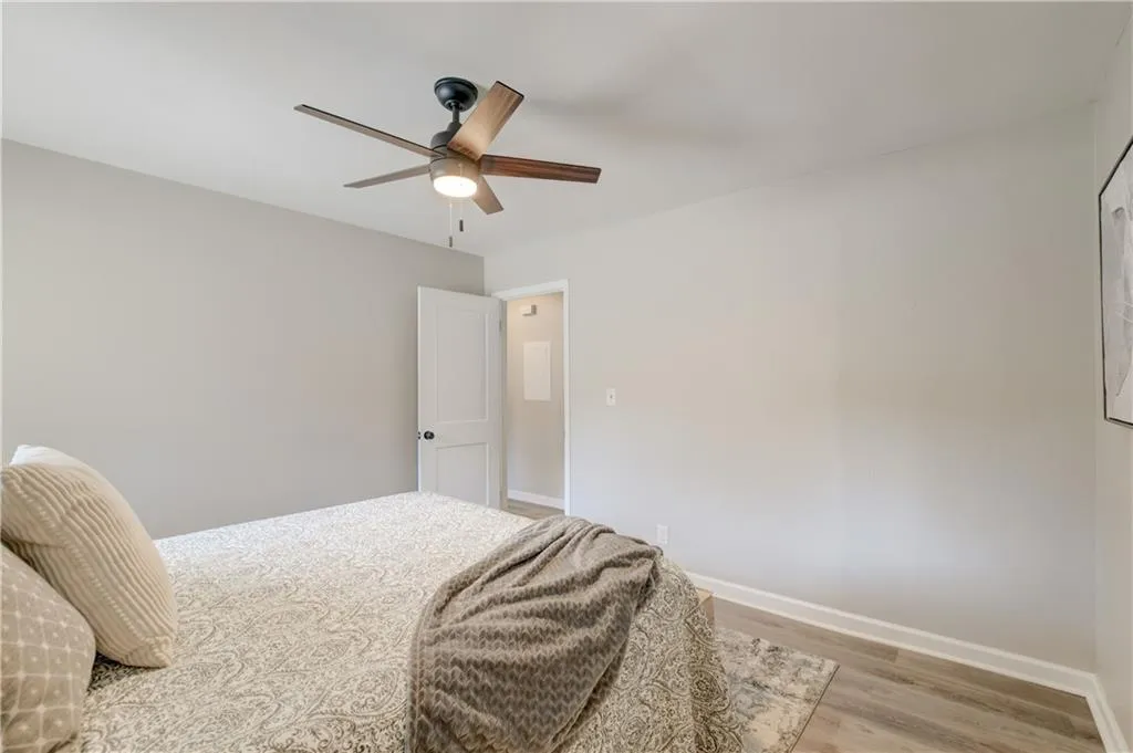 Bedroom with light wood-style floors and ceiling fan