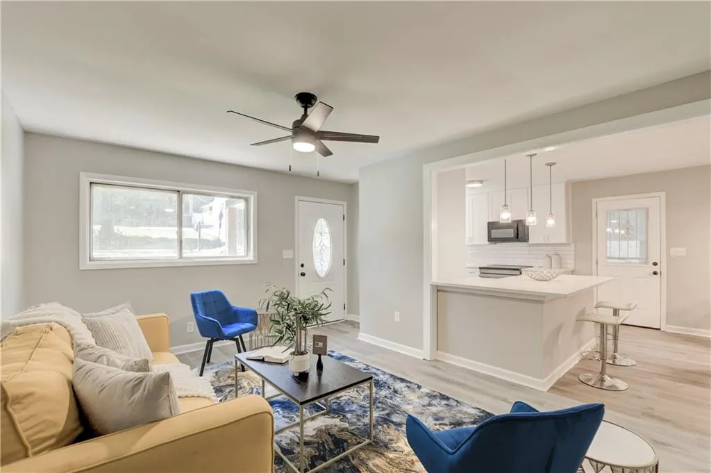 Living room featuring light wood finished floors and a ceiling fan