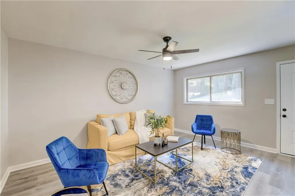 Living room featuring wood finished floors and a ceiling fan