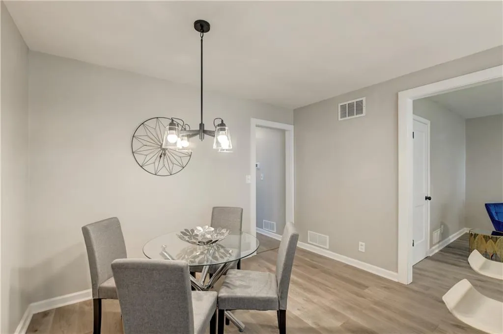Dining space with light wood-style flooring and a chandelier