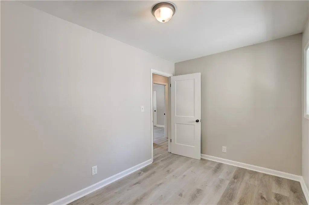 Spare room featuring light wood finished floors and baseboards