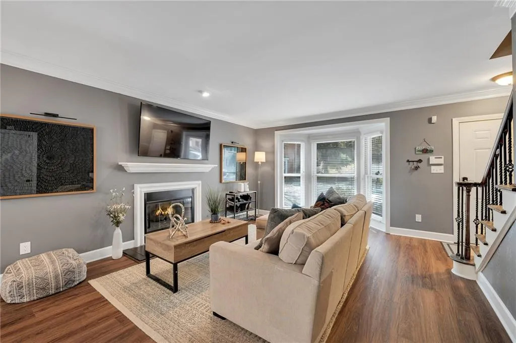 Living room featuring ornamental molding and dark hardwood / wood-style flooring