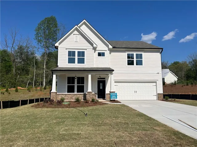 Craftsman-style house with a porch, an attached garage, concrete driveway, and brick siding
