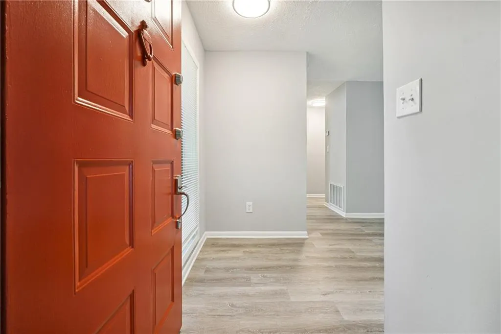 Foyer featuring a textured ceiling and light wood-type flooring