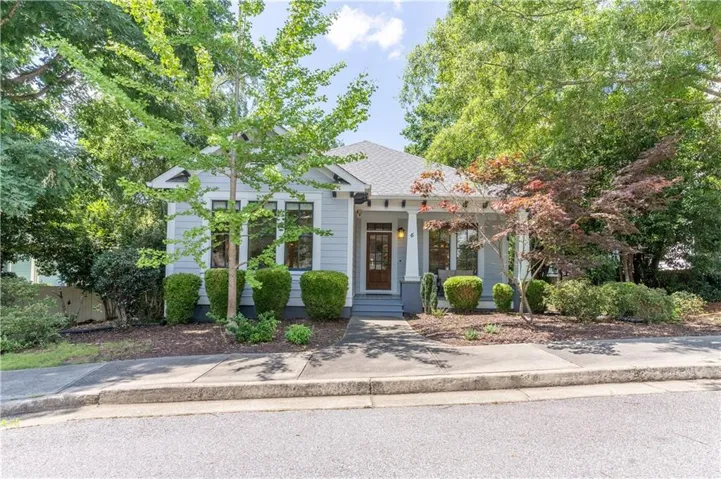 Light gray exterior siding with a covered porch featuring white columns