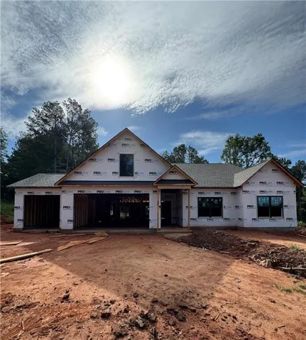 New construction residence with an attached two-car garage, multiple gables, and a prominent front entry