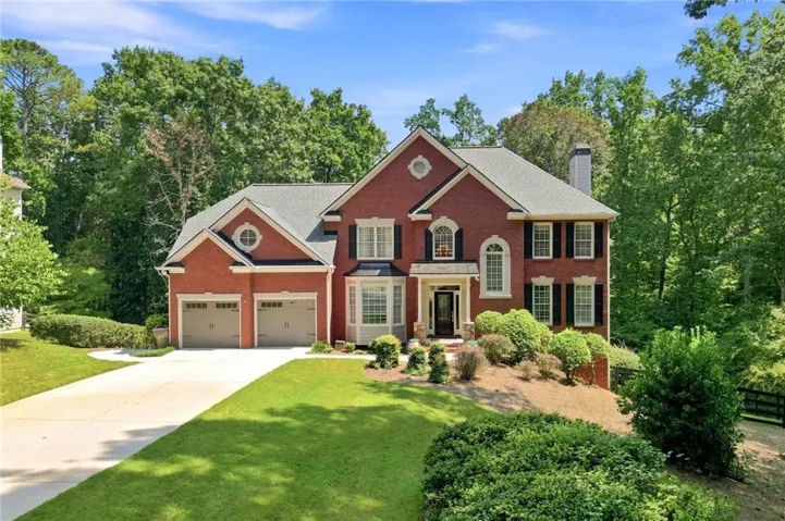 Brick exterior with a gabled roof and two-car garage