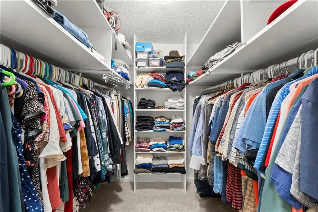 Spacious closet with carpet floors