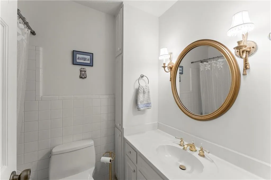 Full bathroom featuring vanity and tile walls