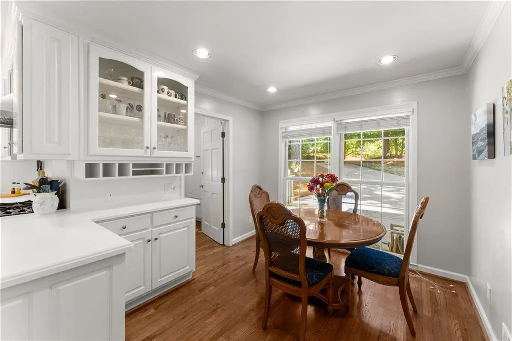 Dining space featuring crown molding, wood finished floors, and recessed lighting