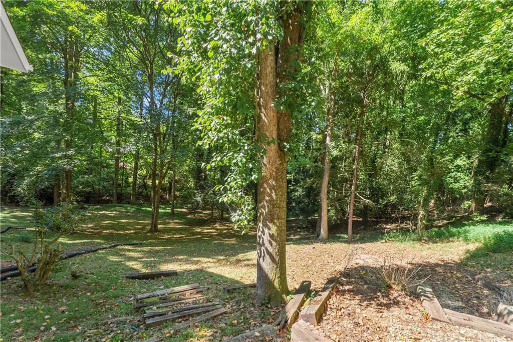 View of yard featuring a view of trees