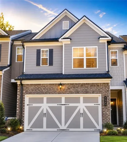 Two-story facade with mixed material construction, featuring brick and siding