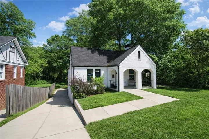 White brick exterior with a black shingle roof