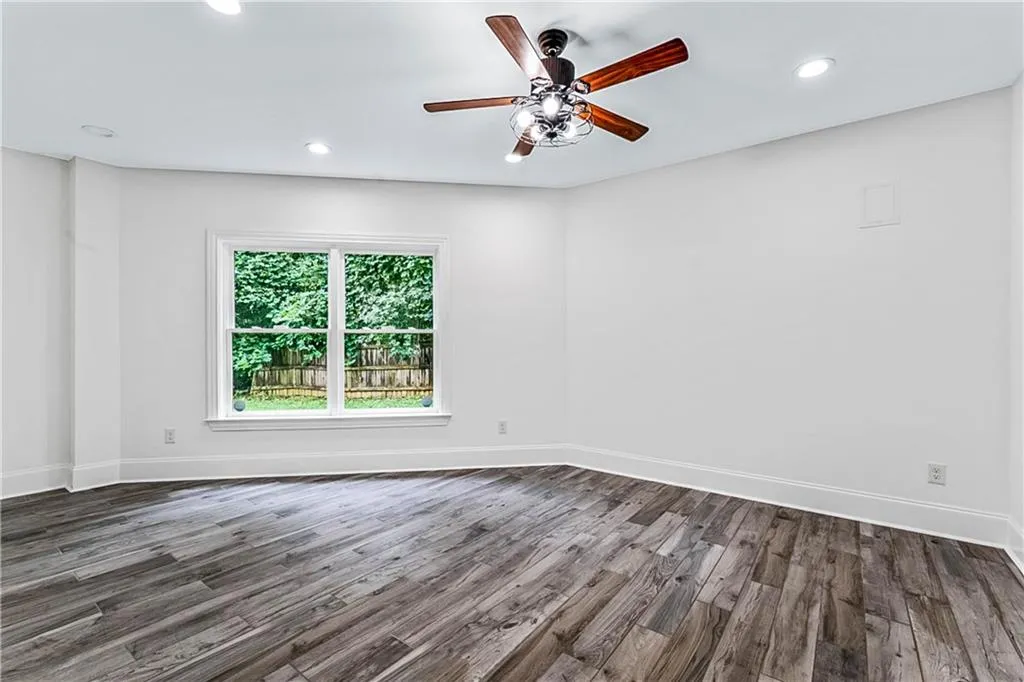 Unfurnished room with dark wood-type flooring, recessed lighting, and a ceiling fan