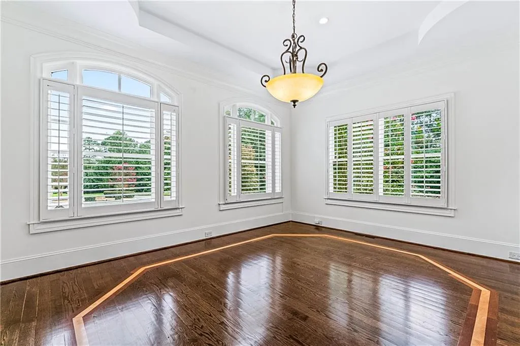 Dining area with crown molding, dark wood finished floors, and recessed lighting