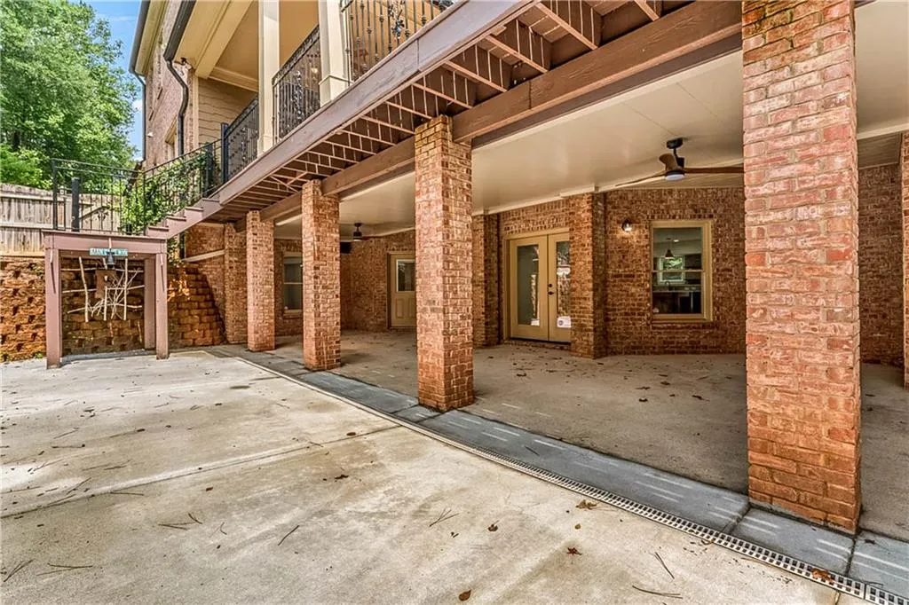 Patio / terrace featuring a ceiling fan, a patio area, stairway, and french doors
