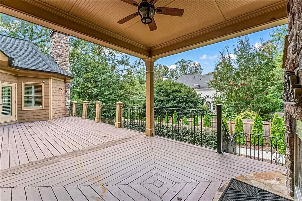 Wooden terrace featuring a ceiling fan