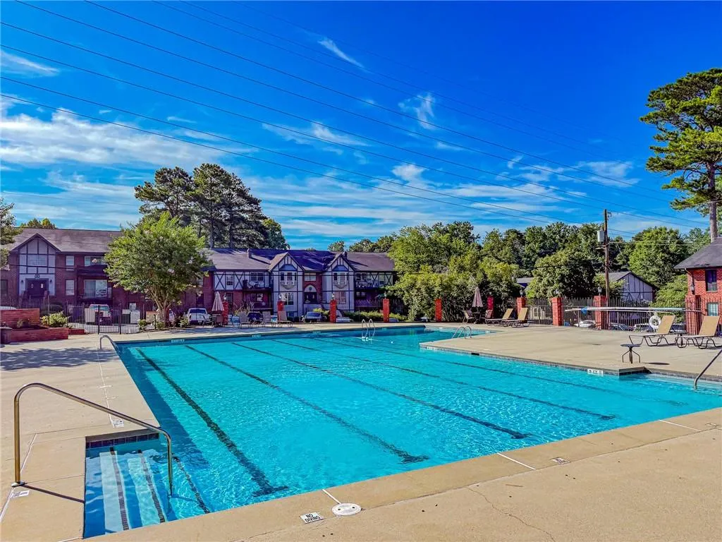 Community pool with a patio