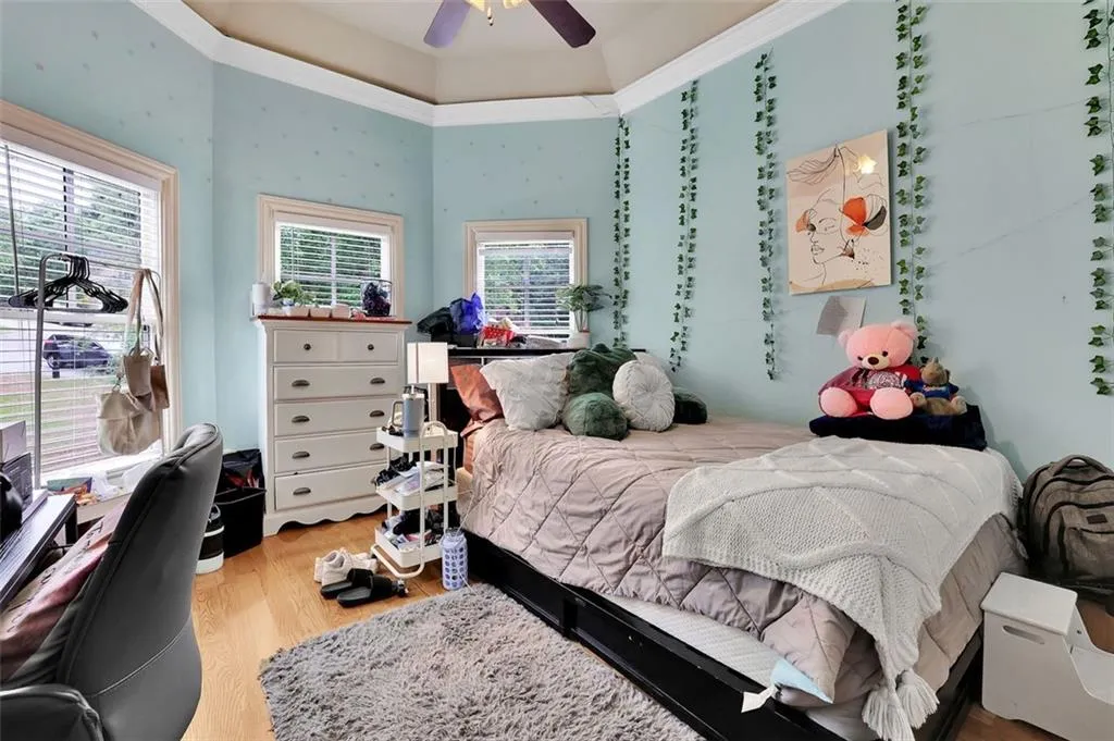 Bedroom with light hardwood / wood-style flooring and ceiling fan