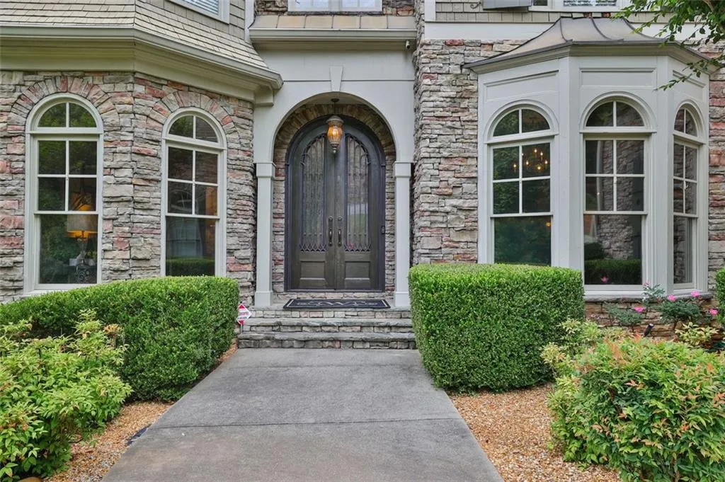 Doorway to property Featuring French iron doorsbeverage cooler, ornamental molding, and light hardwood / wood-style floors