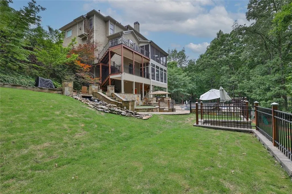 Back of house with a yard and a deck