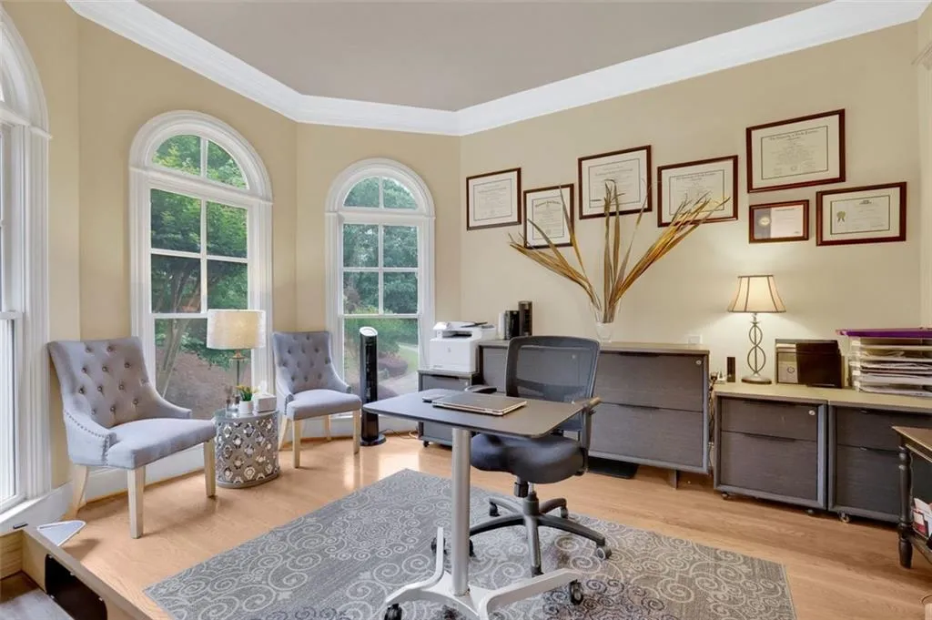 Office/flex space featuring light wood-type flooring and crown molding