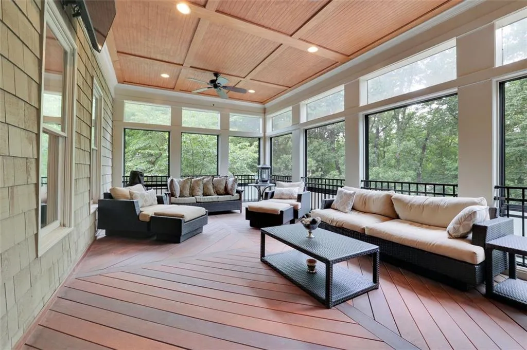 All weather Sunroom / solarium featuring chimnea, wooden ceiling, coffered ceiling, and ceiling fan off of basement level. Can also access basement and sub basement from exterior stairs and daylight entry