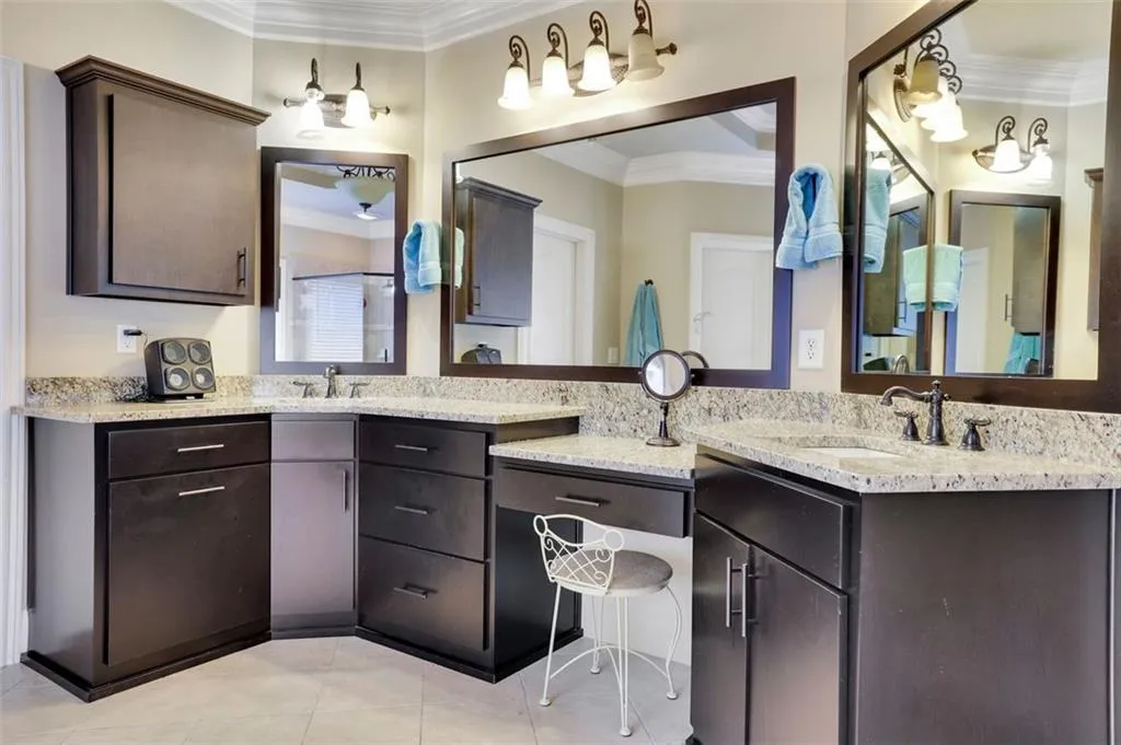 Master Bathroom with dual vanity, ornamental molding, and tile flooring