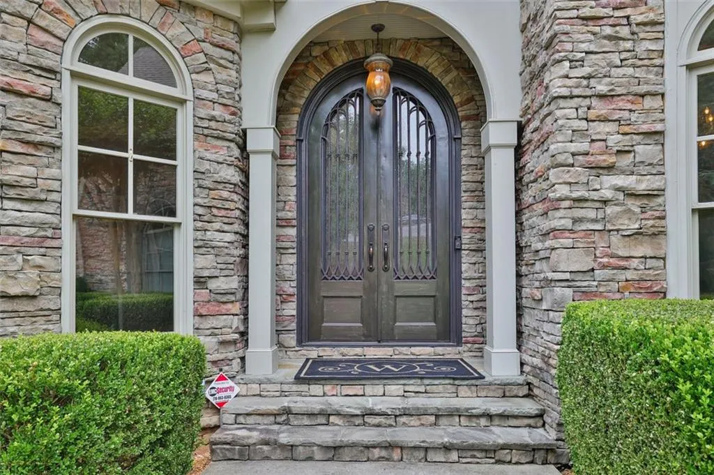 Property entrance with French iron doors
