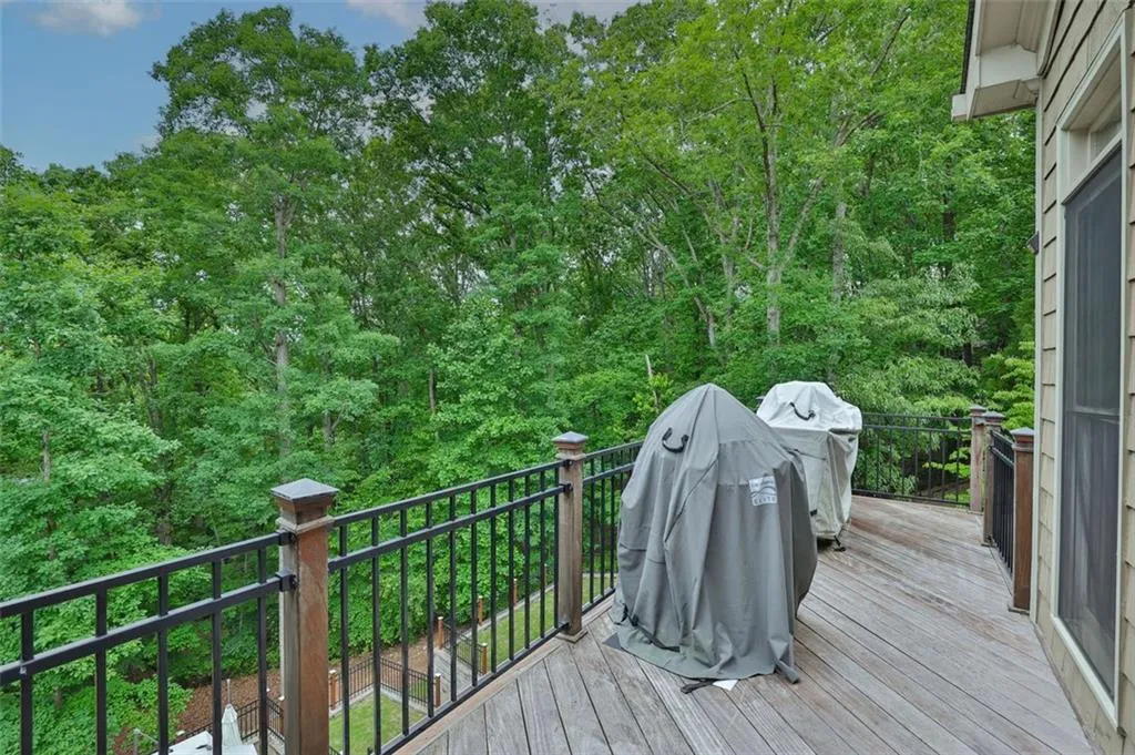 Wooden deck adjacent to screen porch for grilling and sitting